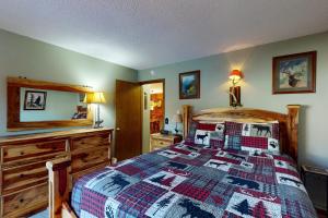 a bedroom with a bed with a quilt on it at Silverado II 421 in Winter Park
