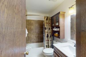 a bathroom with a toilet and a tub and a sink at Silverado II 421 in Winter Park +27 photos