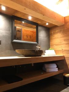 a bathroom with a sink and a mirror at Chalet Au Chalet de Mel très récent in La Bresse +23 photos