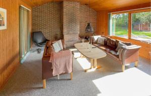 a living room with a couch and a table at Stunning Home In Tarm With Sauna in Højsand