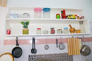 a kitchen with utensils hanging on a wall at Yemane luxury Studio in Mombasa