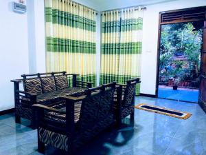 a room with two chairs and a door with a window at Ella Green Breeze in Ella