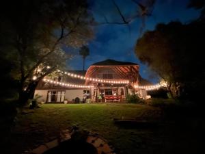 a house with christmas lights on it at night at Sanctuary of The Heart in Fourways +8 photos