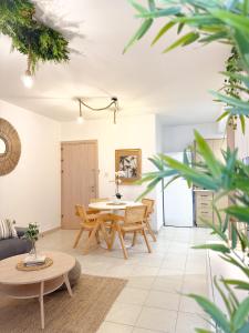 a living room with a table and chairs at Salt & Kozee 2BR Cozy Flat with Pool Access - Near Beaches in Paralimni +18 photos
