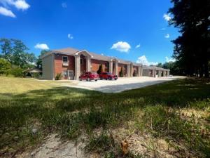 a large house with cars parked in the driveway at Bell's Extended Stay and Suites in Saint Robert