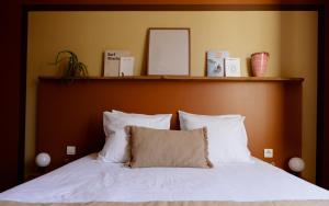 a bed with white pillows and a wooden headboard at Hôtel ROSA - Bordeaux Centre Gare Saint Jean in Bordeaux +30 photos