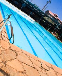 a large swimming pool with a hose in it at Oldoiyo Lengai Resort in Karatina