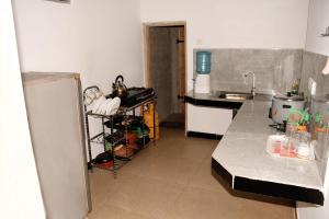a kitchen with a sink and a counter top at Leaf Dew Resort in Anuradhapura