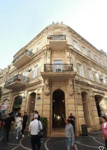 a group of people walking in front of a building at L10nd-on Hotel in Baku +73 photos