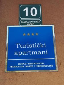 a sign for a turkish parliament on a wall at ILiDZA SKY in Sarajevo +3 photos
