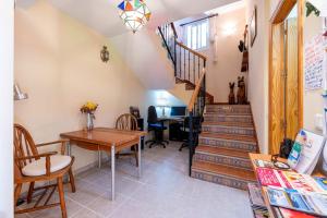a dining room with a table and a staircase at Sunny Getaway in Estepona Dormitory room in Estepona +9 photos