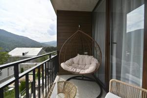 a swing on the balcony of a house at Escapes Boutique Hotel & Restaurant in Dilijan +46 photos