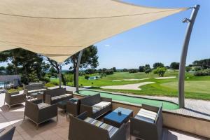 a patio with a view of a golf course at Appartement golf saumane Celomidie in Saumane-de-Vaucluse