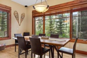 a dining room with a table and chairs and windows at Tramontana 1 - Tramontana Trailhead in Telluride