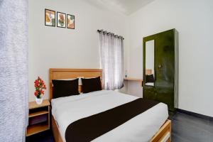 เตียงในห้องที่ Hotel O Thiruvananthapuram Kochuveli Formerly Jasmin Villa +23 ภาพ