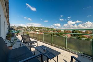 a balcony with a table and chairs and a view at Panorama Apartment & Terrace in Bratislava Center in Vinohrady