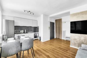 a kitchen and dining room with a table and chairs at Panorama Apartment & Terrace in Bratislava Center in Vinohrady