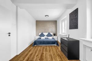 a white bedroom with a bed and a black dresser at Panorama Apartment & Terrace in Bratislava Center in Vinohrady +34 photos