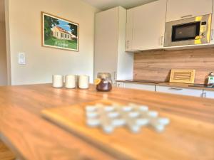 a kitchen with a wooden table with a counter top at Maison La Côtière proche plage avec parking in Camiers