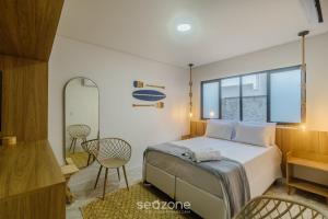 a bedroom with a bed and a table and chairs at Estadia completa com piscina e a 350m da Praia PRY in Porto Seguro +125 photos
