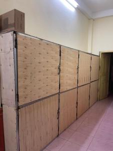 a wooden wall in a room with a box on top at Catty tourist house in Thakhek