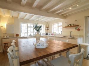 a kitchen with a wooden table with a vase on it at Hambleton House Castle Donington in Castle Donington