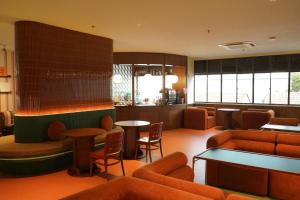 a lobby with a waiting room with tables and chairs at The Très Hotel in Kuala Lumpur +84 photos