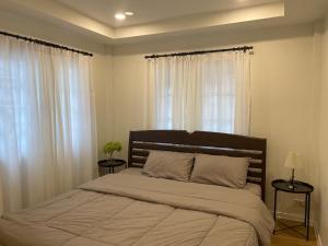 Postel nebo postele na pokoji v ubytování บ้านช่วงเวลาหนึ่ง - House of Moment