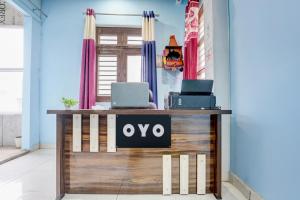 a desk with two laptops on top of it at Hotel O Dream Guest House in Rudrapur