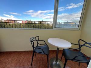 a room with two chairs and a table and a window at Open Door Hostel in Tirana +23 photos