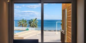 a view of the ocean from a hotel room window at Sea View And Luxury On The Beach in Torrevieja