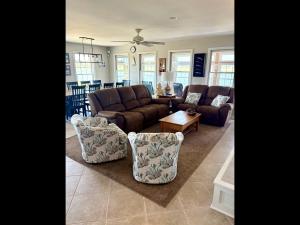 a living room with a couch and chairs at Island Time home in Holden Beach