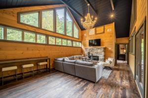 a large living room with a couch and a fireplace at Multi Level Getaway Pool Hot Tub and Fireplace in Pittman Center