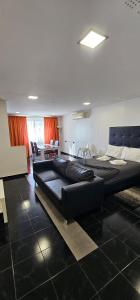 two beds in a room with a living room at Original Apartments in Albufeira