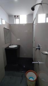 a bathroom with a sink and a toilet and a mirror at Embassy Grand in Jāmb
