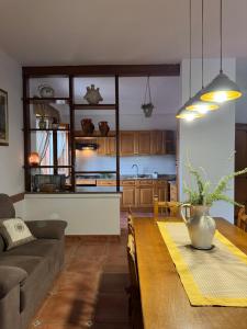 a kitchen and living room with a table and a couch at Benesié - Villa with castle view in Monte San Giovanni Campano +13 photos