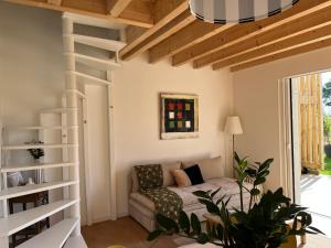 a living room with a couch and a book shelf at HÔME Les hauts du Val in Vantoux