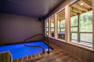 an indoor pool in a house with windows at Multi Level Getaway Pool Hot Tub and Fireplace in Pittman Center
