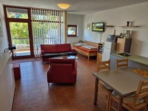 a living room with a couch and a table at APT C-3 v areálu DOKY LIPNO - bezbariérový in Lipno nad Vltavou