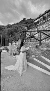 a woman in a white dress holding a bouquet at Holidays Perla d'Amalfi - Live the Coast & Private Parking in Amalfi