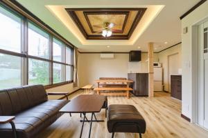 a living room with a couch and a table at テントサウナがある家 余市町 in Kurokawamachi +52 photos