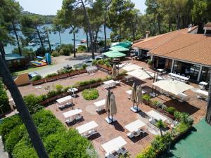 an aerial view of a patio with tables and umbrellas at Camping Village Poljana in Mali Lošinj