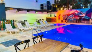 a pool with chairs and tables and a mural at Grand Lavin Hotel in Antalya