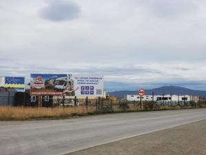 a highway with billboards on the side of a road at Patagonia RV stop in Puerto Natales