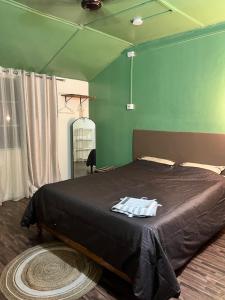 a bedroom with a large bed with a black blanket at Prime Cottage 2bhk independent cottage home in Dimāpur
