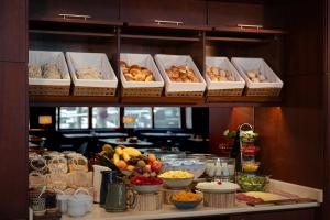 a buffet with many different types of food on a shelf at Hotel Dom Carlos Liberty in Lisbon