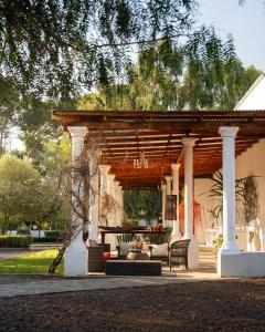 a pavilion with a table and chairs on a patio at Sweetfontein Boutique Farm Lodge in Britstown