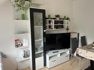 a black and white bookcase with a television in it at Hinter-Apartments West in Rohrbach