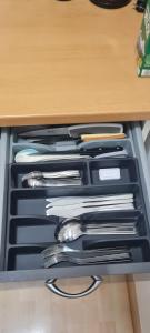 a drawer filled with knives and utensils in a drawer at Hinter-Apartments West in Rohrbach