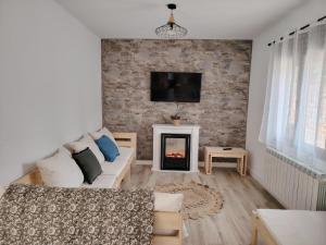 a living room with a couch and a fireplace at Casa TioPito in Vadocondes